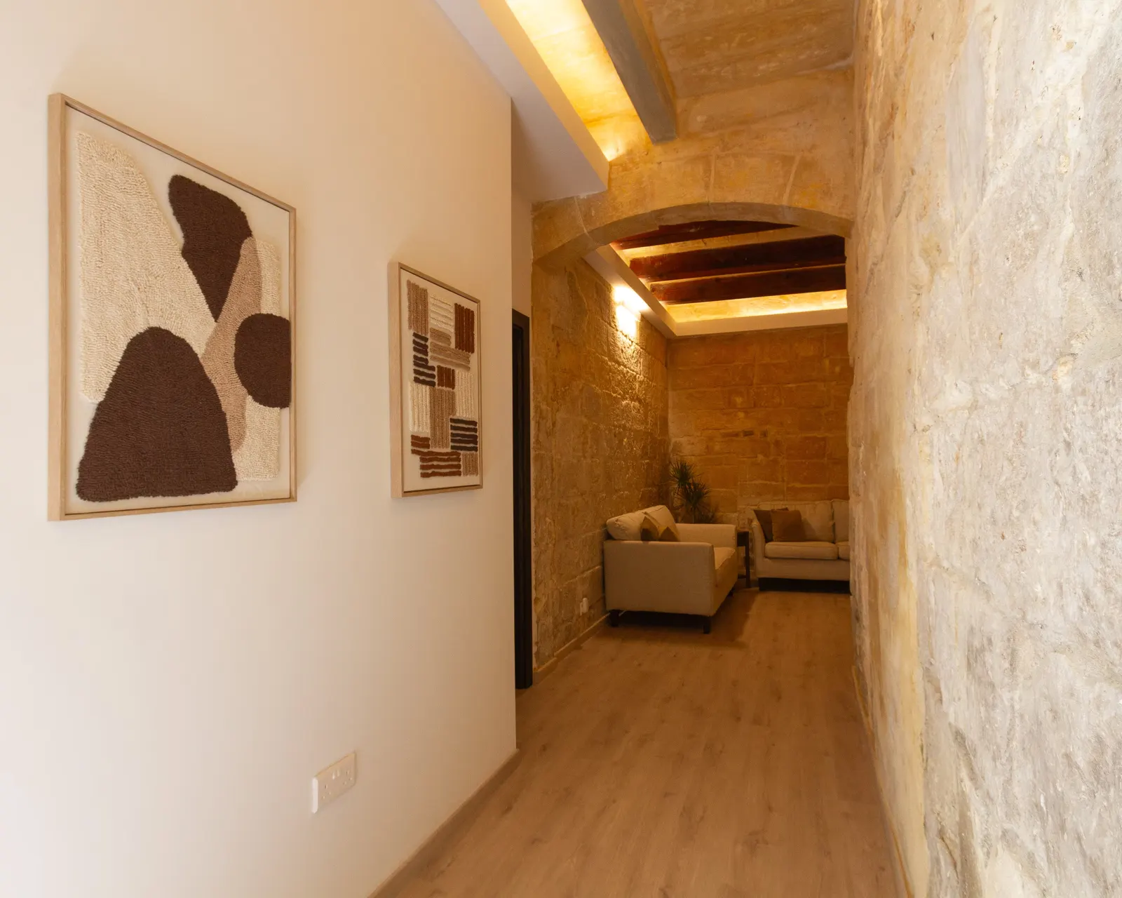 Hallway with artwork leading to the living room