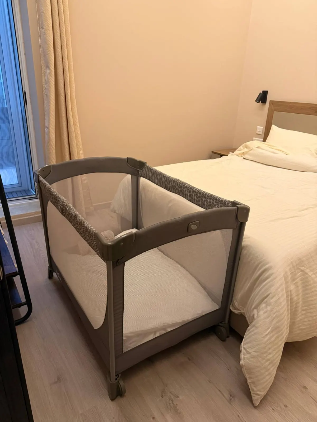 Travel cot beside the queen bed